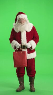 Traditional Santa Claus Holding Red Shopping Bag Footage on Green Screen for Compositing