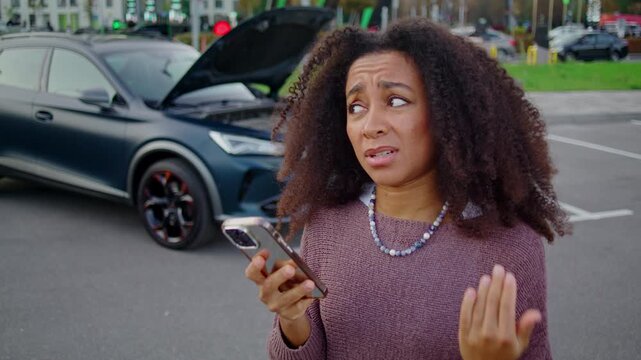 Worried woman calmly discusses unexpected car malfunction