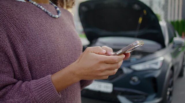 African American woman composes polite text message on smartphone