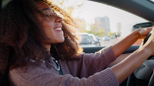 Cheerful African American woman enjoys relaxing drive in sedan