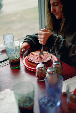 Eating Deep Dish Pizza at Diner Table