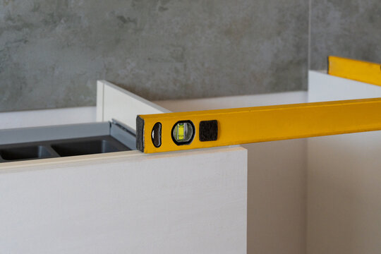 Using Level Tool on new kitchen Cabinet Installation
