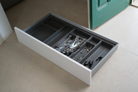 New kitchen drawer with hardware and handles during assembly