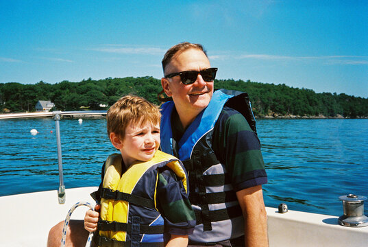 Father and son sailing together in Portland, Maine