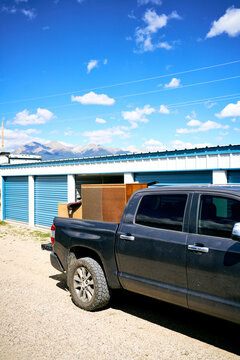 Pickup truck loaded with furniture at storage facility