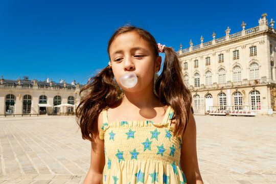 Girl Blowing Bubble Gum at a Palace