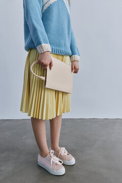 Studio fashion portrait woman with trendy handbag