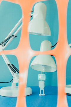 Desk scene with lamps and a figure behind a screen