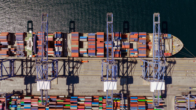 Container ship at industrial port terminal importing export cargo