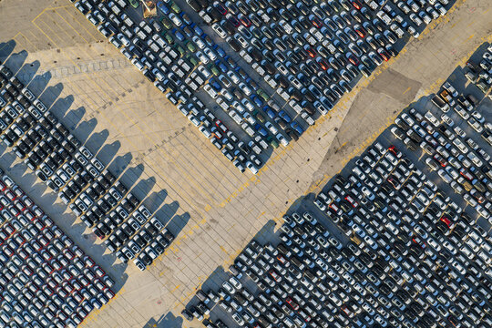 New cars parked in rows at port terminal