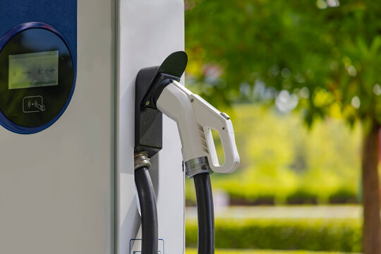 Electric vehicle charging gun mounted on outdoor charging station
