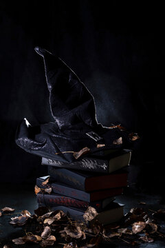 black witch hat on a stack of books