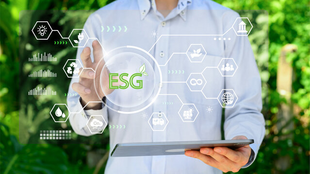 Businessman Touching Virtual ESG Interface While Holding Tablet for Sustainable Investment Strategy Analysis