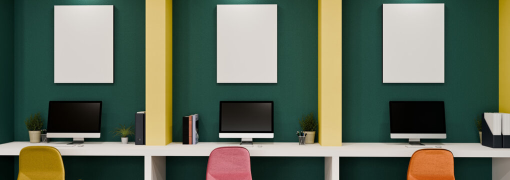 3D Illustration of Creative Workplace with Three Computer Workstations, Colorful Chairs, and Blank Frames on Green Wall