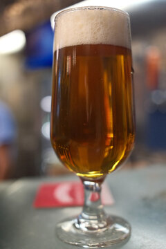 Cold Beer Served in a Glass Mug with Golden Color and Foam