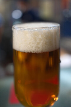 Cold Beer Served in a Glass Mug with Golden Color and Foam
