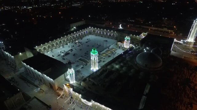 Aerial night view of the illuminated Sheikh Abdul Qadir al-Gilani Mosque at night in Baghdad, Iraq
