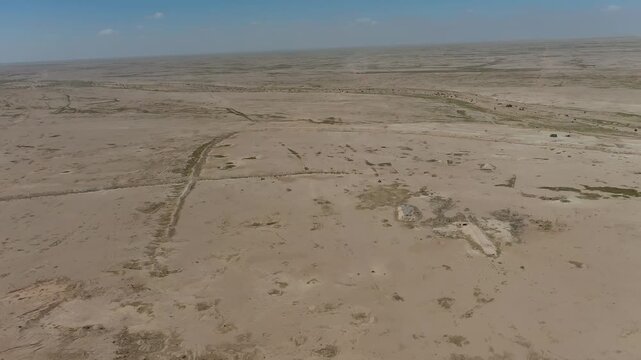 Aerial view of vast empty desert plains and old berms in the Badiya of Samawah, Iraq