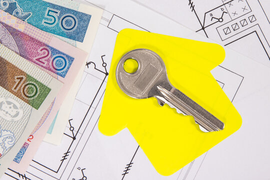 Polish currency banknotes, diagrams of electric installation, key and shape of house. Planning build of home