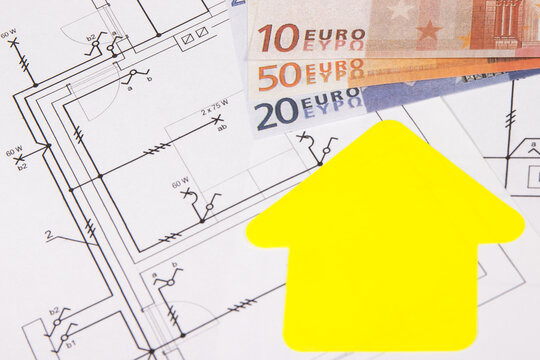 Euro banknotes, diagrams of electric installation and shape of house. Planning build of home