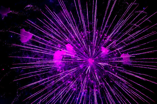 Fireworks close-up. Multicolored fireworks in the night sky, bright festive background with space for text.