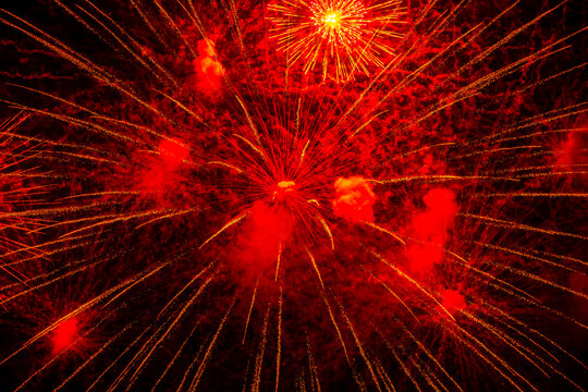 Fireworks close-up. Multicolored fireworks in the night sky, bright festive background with space for text.