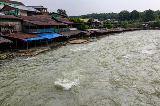 Wooden houses along fast flowing Bohorok River in Bukit Lawang North Sumatra Indonesia