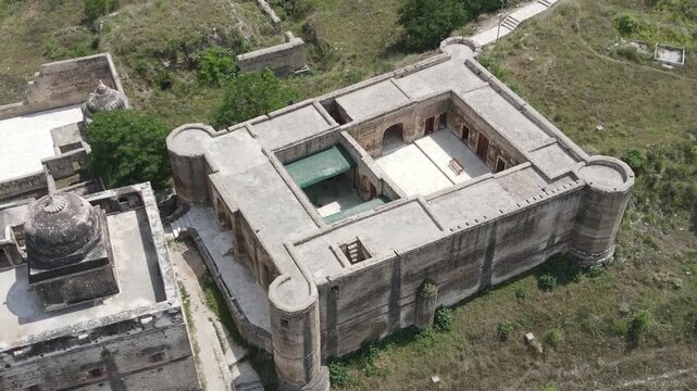 Aerial drone video shot focusing on Hari Singh Nalwa Fort and Haveli structure at the ancient Katas Raj Temples complex in Chakwal, Punjab, Pakistan.