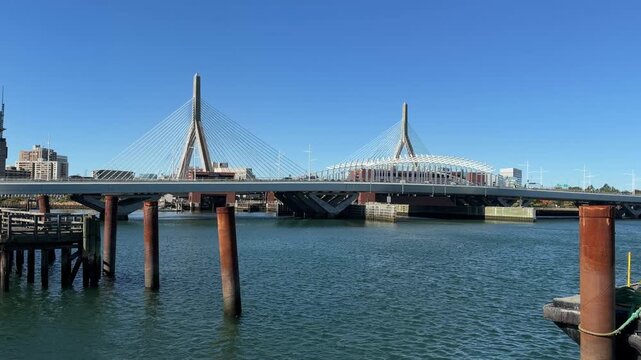 The iconic Leonard P. Zakim Bunker Hill Memorial cable-stayed bridge spanning the Charles River under clear blue skies in Boston, Massachusetts. Conformed 4K