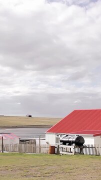 Panning Shot Of Rural Farmhouse With Red Roof In Darwin Falkland Islands (Malvinas) - 4K Vertical