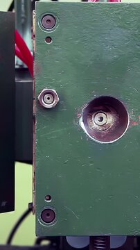 Factory Worker Operating Heavy Green Industrial Machine - Vertical 4K