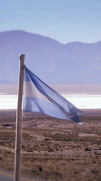 Argentine Flag Waving In The Wind At Salinas Grandes Salt Flat - Vertical 4K