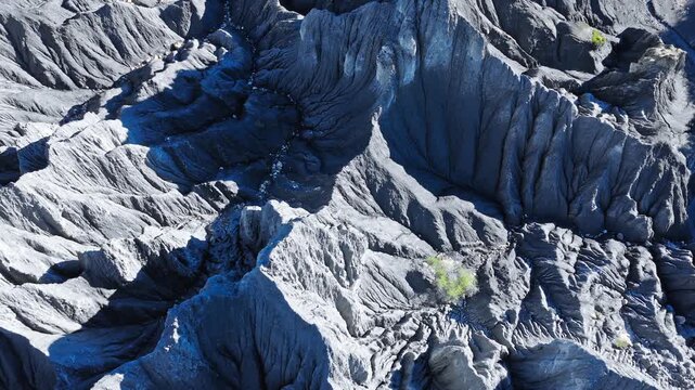 High angle view captures dramatic grey rock formations at Moshi Park in Sichuan, highlighting sharp textures under bright sunlight.