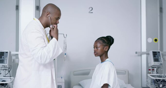 African American doctor and youth starting exam, listening with steth checking lungs high-fiving
