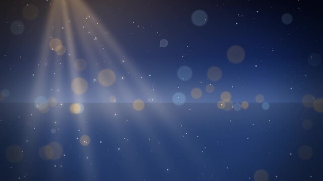 Soft light rays through falling snow glowing winter night lights
