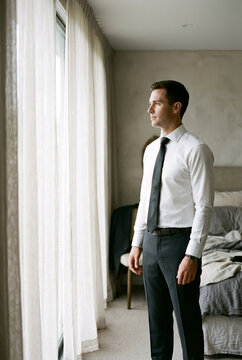 Groom Preparing for Wedding in Bedroom, Elegant Morning Ritual and Grooming Concept