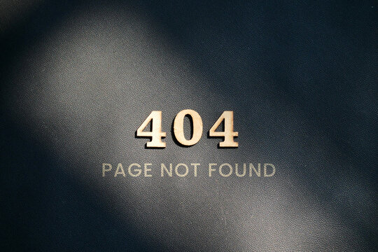 Dark textured background with the words 404 PAGE NOT FOUND using wooden numbers representing a website error or broken link concept