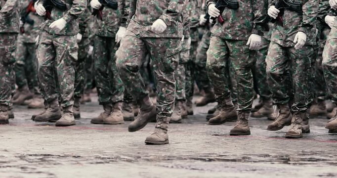 Romanian army soldiers prepare to march during a military ceremony.