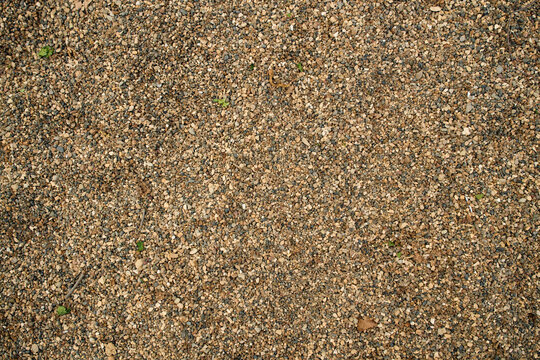 Flat lay of granular sandy soil ground surface, ideal for natural wallpaper, textured screensavers