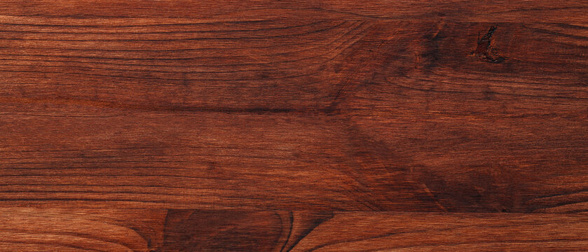 Reddish brown wood boards with dark knots and fine linear grain forming a warm rustic background