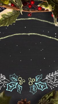 Vertical video: Loading chalkboard frame showing holly pinecone glint arcs forming greeting