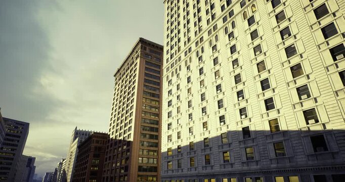 Soft morning light on classic office block with ornate details, photographer frames warm stone, window rows and textured facades to highlight timeless