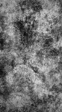 Vertical video: Speckles rising causing surface forming dark cracks then reverting to smudges