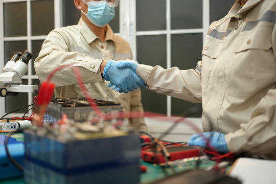 The skilled technician works on the lithium phosphate battery circuit board with his partner.