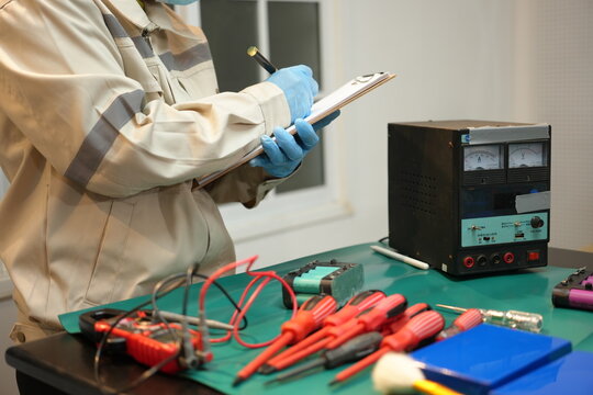 The skilled technician works on the lithium phosphate battery circuit board with his partner.