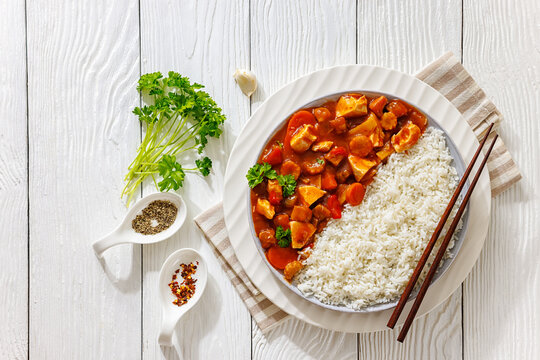 Asian chicken in sweet sauce served next to rice