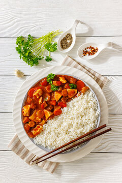 Asian chicken in sweet sauce served next to rice