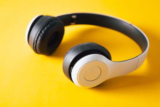 Headphones on a yellow background. Top view with copy space.