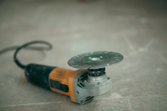 Electric grinder on the floor.