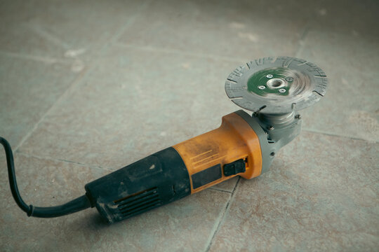 Electric grinder on the floor.